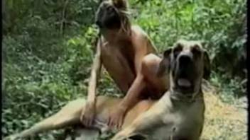 Brunette pup dominating her master in the woods