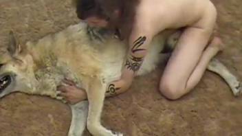 Tatted-up guy fucks a submissive dog on the floor