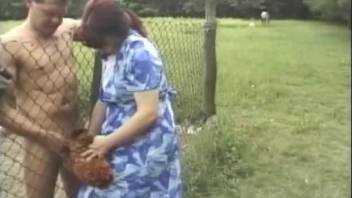Red get-up brunette spreading her legs for a dog