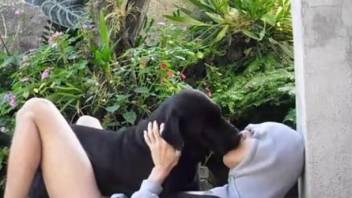 Sexy lover and black rottweiler have amazing sex in the garden