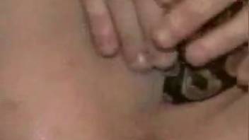 Dark-haired woman thrusts a real snake into her vagina