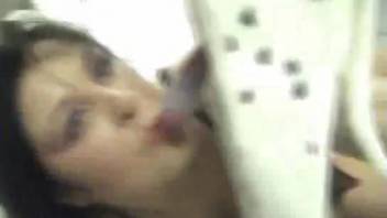 Curvy brown-haired woman performs oral on a white dog after anal pleasure.
