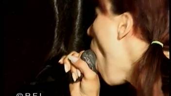 Ginger woman with braids performing oral sex on a dark horse's penis