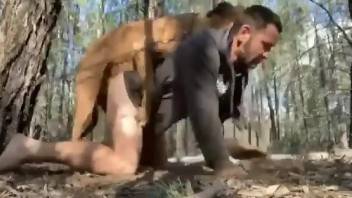 Half naked man fucked in the ass by his dog while out into the woods