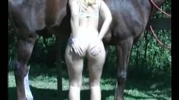 Horny blonde enjoying hardcore sex with a horse