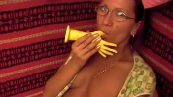 Geeky mature woman mounting a canine's penis on the sofa